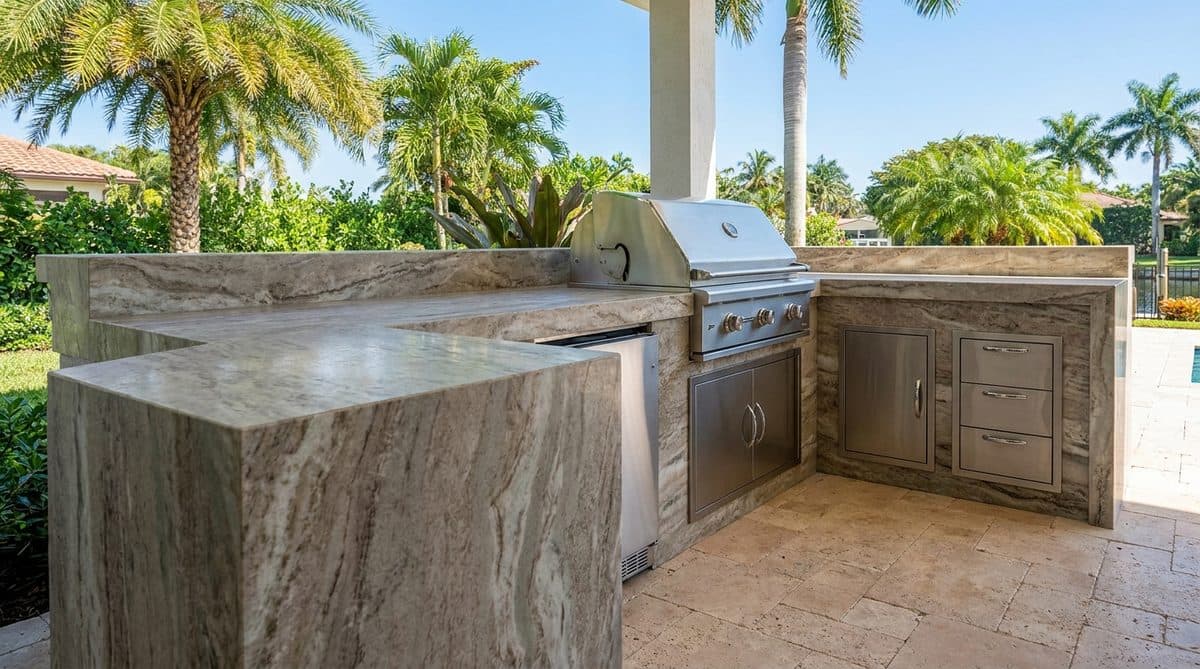 Finished outdoor kitchen in South Florida — real stone, real install