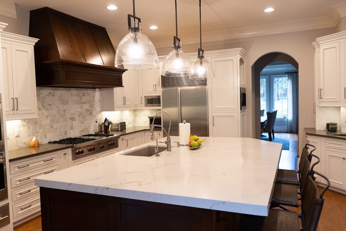 White veined quartz island in a finished kitchen